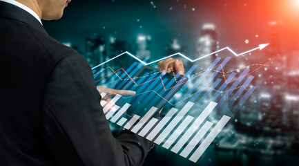 A businessman analyzes financial data using a digital interface displaying market trends and graphics, set against a futuristic city skyline, representing business and technology convergence. Scalp
