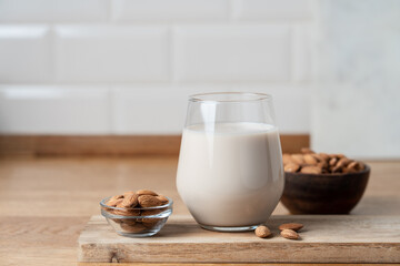 Glass of Vegan Almond Milk on Wooden Kitchen Countertop, Healthy Plant Based Nutrition Concept