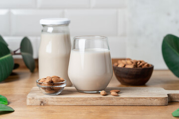 Glass of Vegan Almond Milk on Wooden Kitchen Countertop, Healthy Plant Based Nutrition Concept