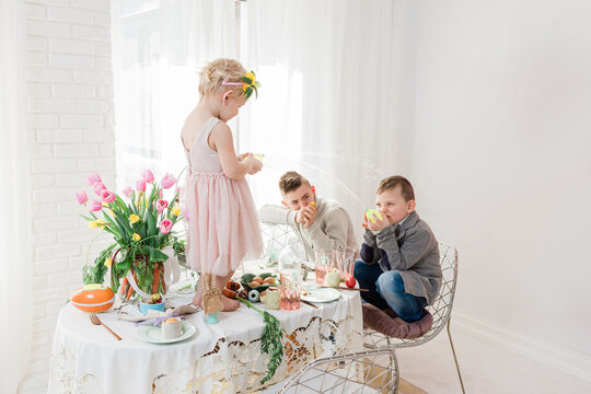 Kids playing on Dyngus Day at breakfast table - Easter Monday in Poland