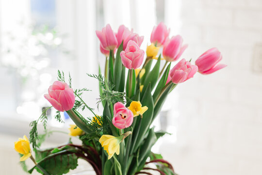 Bouquet of fresh tulips and carrots as unique Easter table decor