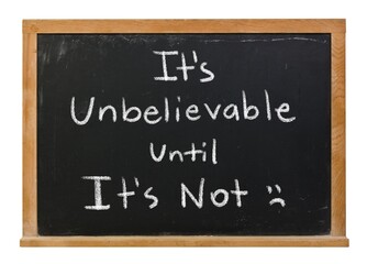 Fototapeta premium It's unimaginable unbelievable until it's not handwritten in white chalk on a black chalkboard in a wooden frame isolated on white.