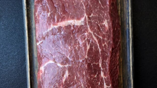 A piece of raw beef, a tenderloin for grilling or barbecue. Raw beef as a food background for your design