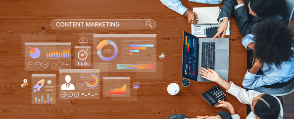 A diverse team collaborates on a content marketing strategy in a modern workspace. Data visualizations and statistics support their planning efforts and decision-making. Trope