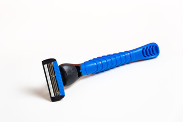 Plastic razor isolated on a white background. New disposable razor blade. Closeup.