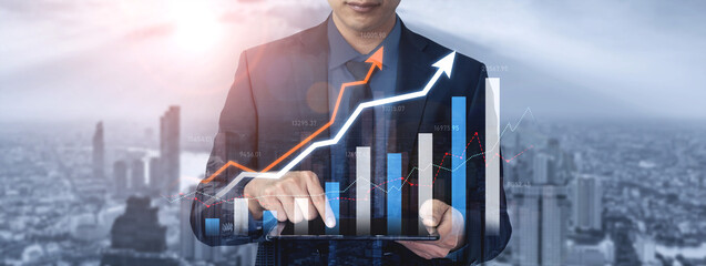 A businessman interacts with digital financial graphs on a tablet, set against a dynamic city skyline, showcasing growth and success in a modern business setting. Scalp