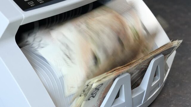 Poland money. Converting Polish currency in a machine. Lots of cash. Banking, cash exchange in exchange offices. Financial concept. Business background. closeup