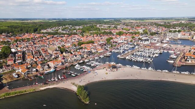 thin sandy beach separates coastal waters marinas filled hundreds boats high dense residential center urk netherlands from angle aerial view flevoland high-angle housing 