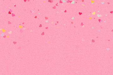 Shimmering pink glitter background adorned with a vibrant cascade of multi-colored heart confetti © sobuj