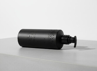 Fototapeta premium Black Pump Bottle With Lotion On White Surface — Minimal Skincare Container