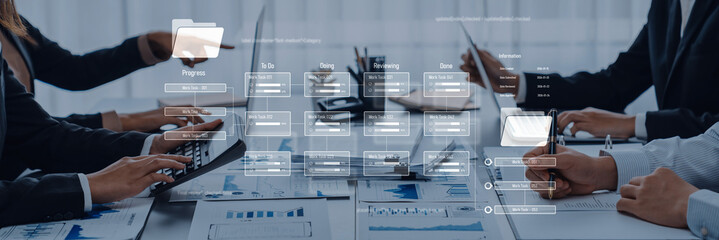 Business professionals engage in collaborative work at a conference table, analyzing digital data and financial reports on a modern workspace for strategic planning. Trope