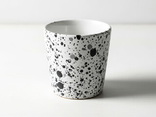 Modern ceramic mug with black speckled design