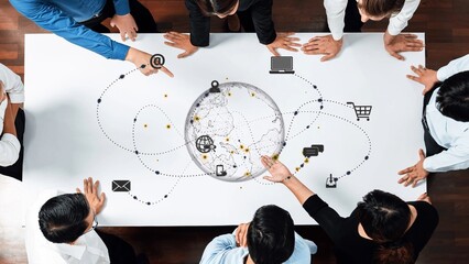 A diverse group of professionals collaborates around a table, analyzing a world globe graphic symbolizing global connectivity and modern business strategies. Raster