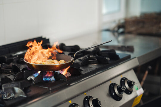 Intense restaurant kitchen activity with vibrant lighting effects
