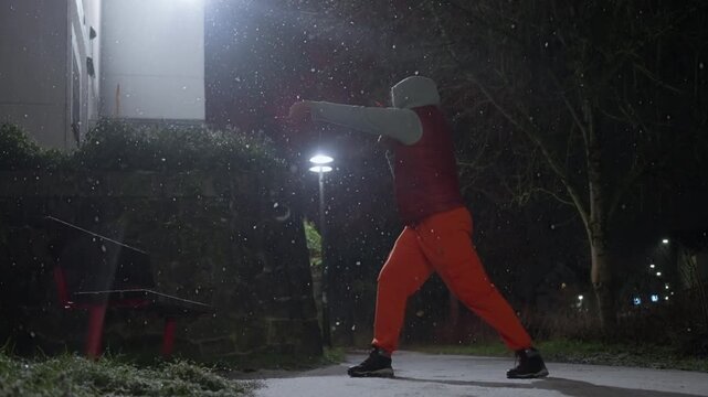 Fighter Shadow Boxes In Winter Snow, Snowcovered Boxing Training With Lone Athlete Practicing Punches, Solitary Boxer Rehearsing Shadow Boxing Moves Outdoors Amidst Blanket Of Winter Snow
