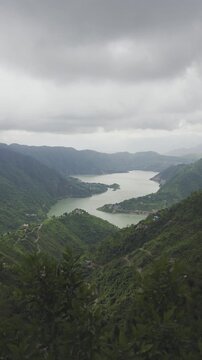 KOL DAM, INDIA - JANUARY 19, 2026: An aerial/high-angle scenic view of the Satluj River and Kol Dam reservoir surrounded by lush green mountains in Himachal Pradesh
