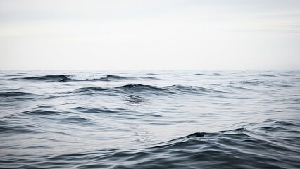 Ocean waves under cloudy sky