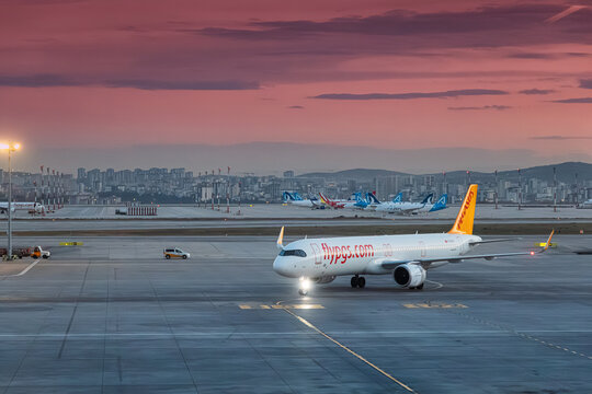 ISTANBUL, TURKEY - NOVEMBER 28, 2025: Pegasus Airlines Airbus A321 neo taxiing at Sabiha Gokcen Airport (SAW) during a pink sunset