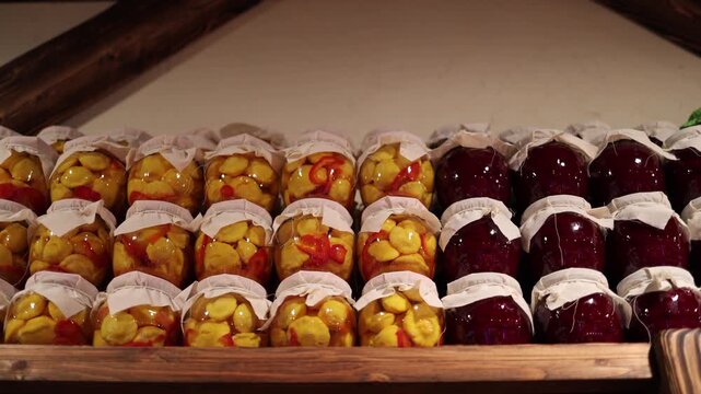 Homemade fruit preserves arranged in neat rows on wooden shelves creating a warm rustic atmosphere with bright colors natural ingredients and traditional pantry storage mood