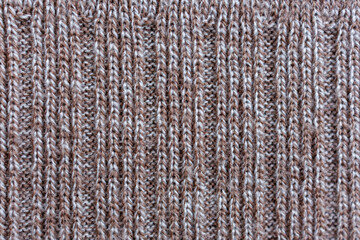 Fototapeta premium Close up of brown knitted textile texture with deep rib pattern presented as abstract winter fabric surface