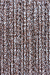 Fototapeta premium Brown and beige knitted fabric texture with repeating rib structure photographed as abstract warm textile background