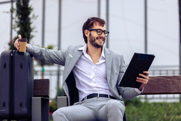 Young Businessman Reviewing Paper Report on Bench