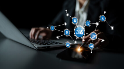 A professional setting depicts a person engaging with finance-related icons on devices, illustrating the integration of technology and business in today digital world. Tessel