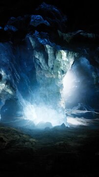 Icy blue glacier cave glowing inside, crystalline walls and towering icicles framing luminous entrance, soft cold mist, deep blue tones, ambient shaft of light,
