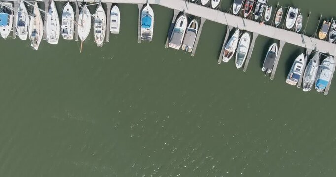 Aerial view of Suomenoja Marina, featuring numerous sailboats and yachts docked along a pier in summer, Espoo, Finland.
