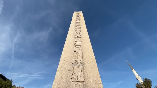 Obelisk of Theodosius (Turkish: Dikilitas) on Sultanahmet Hippodrome Square at the Eminonu District in Istanbul, Turkey. (4K tilt video)