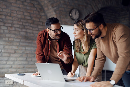Diverse group of young professionals collaborating on a project in a modern startup office - Powered by Adobe