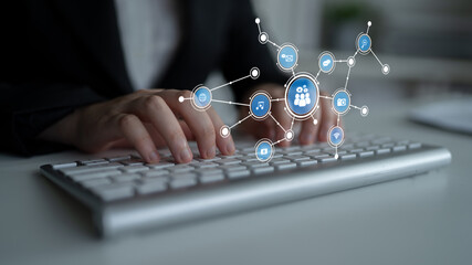 A close-up of hands typing on a keyboard in a modern office, with digital connection icons overlaying to represent technology, communication, and networking ideas. Tessel