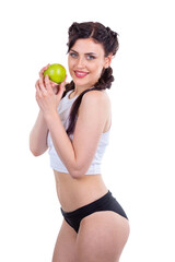 Side view of fit woman holding green apple wearing sportswear isolated on white background