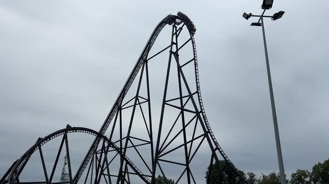 Energylandia, high-speed roller coaster climbs steep track at an amusement park