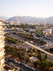 View of Palermo, Sicily, featuring beautiful roads lined with modern houses and urban development under a clear sky. Contemporary cityscape highlighting the blend of modern architecture and