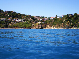 Beautiful blue blue sea along the coast of Catania, Sicily, showcasing clear Mediterranean waters and scenic shoreline under a bright sky. Natural coastal landscape highlighting the charm of eastern