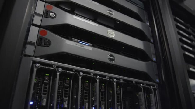 Close-up of a Dell server with multiple hard drives in a dark data center with a focus on computer hardware