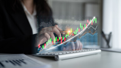 A businesswoman analyzes financial data on a laptop while interacting with digital graphs depicting stock trends in a contemporary office environment. Impute