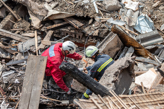 Rescue workers clearing debris at collapsed building site