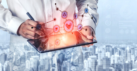 A business professional interacts with a tablet, showcasing digital icons that symbolize technology and connectivity. The cityscape background adds a modern touch. Tessel