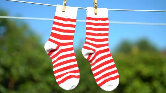 Striped socks in bright minimal style, red and white colors, laundry drying outdoors