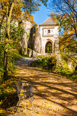 Entrance path to castle in autumn fall colors of trees in Ojcow National Park, Poland