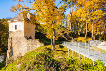 View of old castle in park with autumn fall colors of trees in Ojcow National Park, Poland