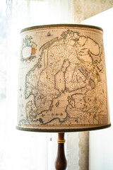 Vintage map lampshade featuring an old Nordic map, creating a warm Scandinavian interior atmosphere with travel-inspired decor and timeless character