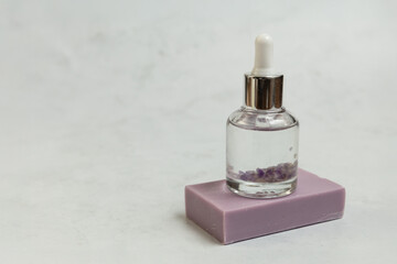 Bottle of body oil sitting on homemade soap