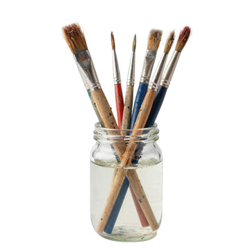 Glass Jar with Assorted Used Paintbrushes on White Background