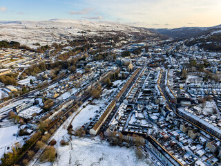 Scenic winter landscape showing terraced houses and snowy hills in Ebbw Vale, Wales