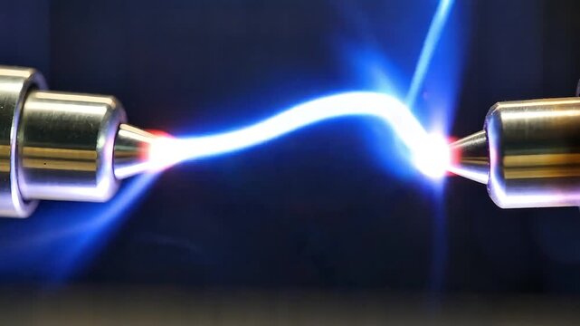 Two metal electrodes generating bright electric discharge representing plasma high voltage energy flow