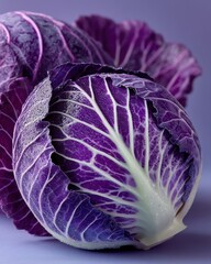 Obraz premium Closeup of purple cabbage halved on soft surface
