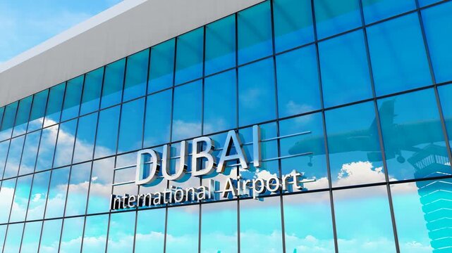 Dubai international airport. Plane landing at Dubai. Arrival in the city with the glass airport terminal and reflection of the jet aircraft. Travel, business, tourism and transport.
